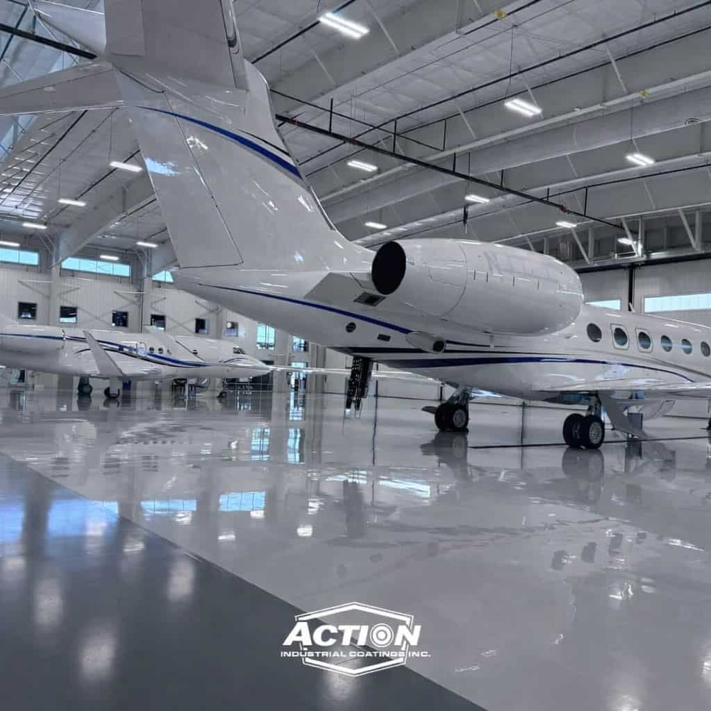 High-gloss epoxy polyurea floor coating in an aircraft hangar, demonstrating industrial-grade performance
